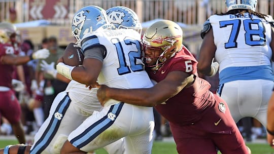 Nov 2, 2024; Tallahassee, Florida, USA;  Florida State Seminoles defensive tackle Darrell Jackson Jr (6) sacks North Carolina Tarheels quarterback Jacolby Criswell (12) in the second quarter at Doak S. Campbell Stadium. Mandatory Credit: Robert Myers-Imagn Images