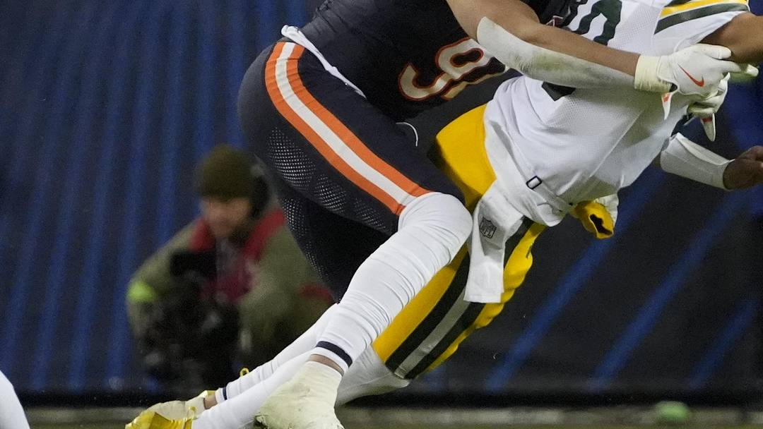 Green Bay Packers quarterback Jordan Love throws the ball as he is hit from behind druing the playoff loss at the Bears.
