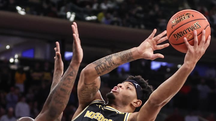 Dec 10, 2024; New York, New York, USA;  Michigan Wolverines guard Roddy Gayle Jr. (11) shoots over Arkansas Razorbacks guard Johnell Davis (1) in the second half at Madison Square Garden. Mandatory Credit: Wendell Cruz-Imagn Images