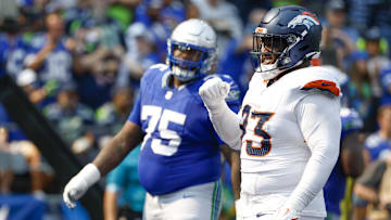 Sep 8, 2024; Seattle, Washington, USA; Denver Broncos defensive tackle D.J. Jones (93) celebrates a holding penalty against Seattle Seahawks guard Anthony Bradford (75) for a safety during the second quarter at Lumen Field.
