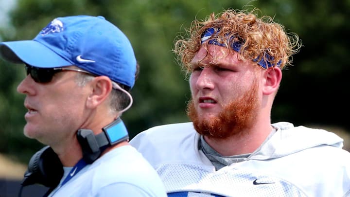 MTSU's offensive coordinator Mitch Stewart watches the players practice as MTSU's offensive lineman Keylan Rutledge (77) stands behind him during MTSU's football practice on Wednesday, Aug. 2, 2023.