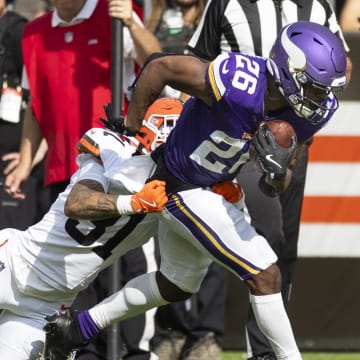 Aug 17, 2024; Cleveland, Ohio, USA; Minnesota Vikings running back Kene Nwangwu (26) runs the ball as Cleveland Browns cornerback Vincent Gray (31) tackles him during the first quarter at Cleveland Browns Stadium. Mandatory Credit: Scott Galvin-USA TODAY Sports