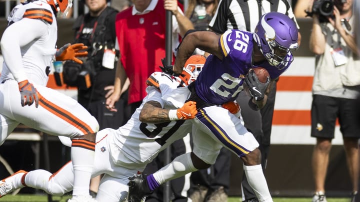 Aug 17, 2024; Cleveland, Ohio, USA; Minnesota Vikings running back Kene Nwangwu (26) runs the ball as Cleveland Browns cornerback Vincent Gray (31) tackles him during the first quarter at Cleveland Browns Stadium. Mandatory Credit: Scott Galvin-USA TODAY Sports