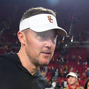 Nov 7, 2025; Los Angeles, California, USA; Southern California Trojans head coach Lincoln Riley meets with wife Caitlin and daughers Sloan and Stella following the victory against the Northwestern Wildcats at the Los Angeles Memorial Coliseum. Mandatory Credit: Gary A. Vasquez-Imagn Images