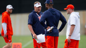 Auburn Tigers head coach Hugh Freeze talks with offensive coordinator Derrick Nix during practice.