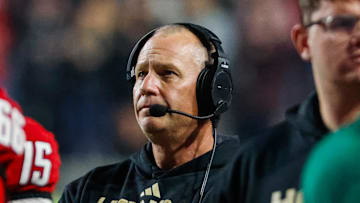 Nov 21, 2025; Raleigh, North Carolina, USA;  NC State Wolfpack head coach Dave Doeren looks on during the second half of the game against Florida State Seminoles at Carter-Finley Stadium. Mandatory Credit: Jaylynn Nash-Imagn Images