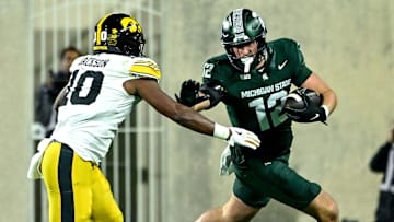 Michigan State's Jack Velling, right, runs after a catch as Iowa's Nick Jackson closes in during the third quarter on Saturday, Oct. 19, 2024, at Spartan Stadium in East Lansing.