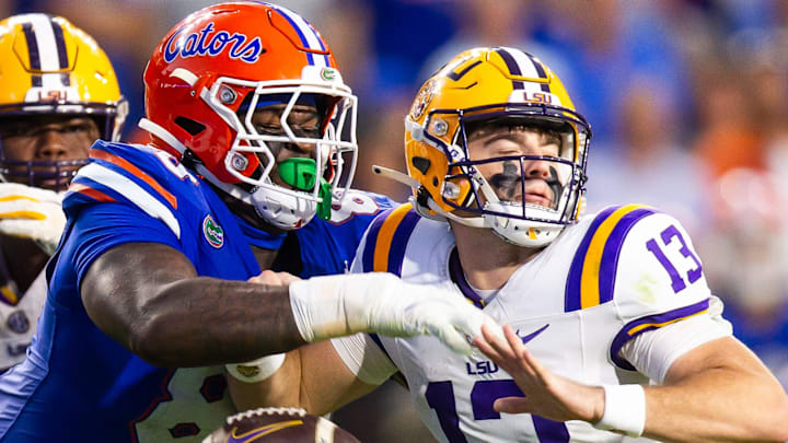 Florida Gators defensive lineman Caleb Banks (88) causes a fumble as he strips the ball from LSU Tigers quarterback Garrett Nussmeier (13) during the second half at Ben Hill Griffin Stadium in Gainesville, FL on Saturday, November 16, 2024. The Gators defeated the Tigers 27-16. [Doug Engle/Gainesville Sun]