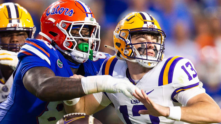 Florida Gators defensive lineman Caleb Banks (88) causes a fumble as he strips the ball from LSU Tigers quarterback Garrett Nussmeier (13) during the second half at Ben Hill Griffin Stadium in Gainesville, FL on Saturday, November 16, 2024. The Gators defeated the Tigers 27-16. [Doug Engle/Gainesville Sun]