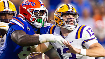 Florida Gators defensive lineman Caleb Banks (88) causes a fumble as he strips the ball from LSU Tigers quarterback Garrett Nussmeier (13) during the second half at Ben Hill Griffin Stadium in Gainesville, FL on Saturday, November 16, 2024. The Gators defeated the Tigers 27-16. [Doug Engle/Gainesville Sun]