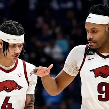 Arkansas Razorbacks Trevon Brazile (4) and Jonas Aidoo (9) congratulate each other after their win against South Carolina in a first round game at the men’s SEC Tournament in Nashville, Tenn.