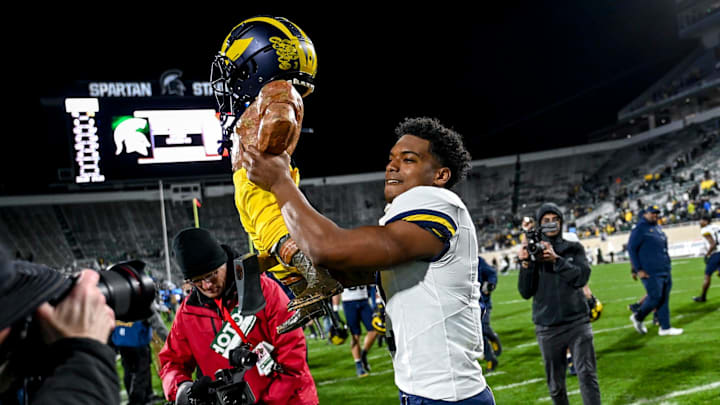 Michigan's Will Johnson celebrates with the Paul Bunyan trophy after beating Michigan State on Saturday, Oct. 21, 2023, at Spartan Stadium in East Lansing.