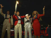 Carl Lewis, Rafael Nadal, Nadia Comaneci and Serena Williams travel with the Olympic Flame down the Seine River at the 2024 Paris Olympic Opening Ceremony.