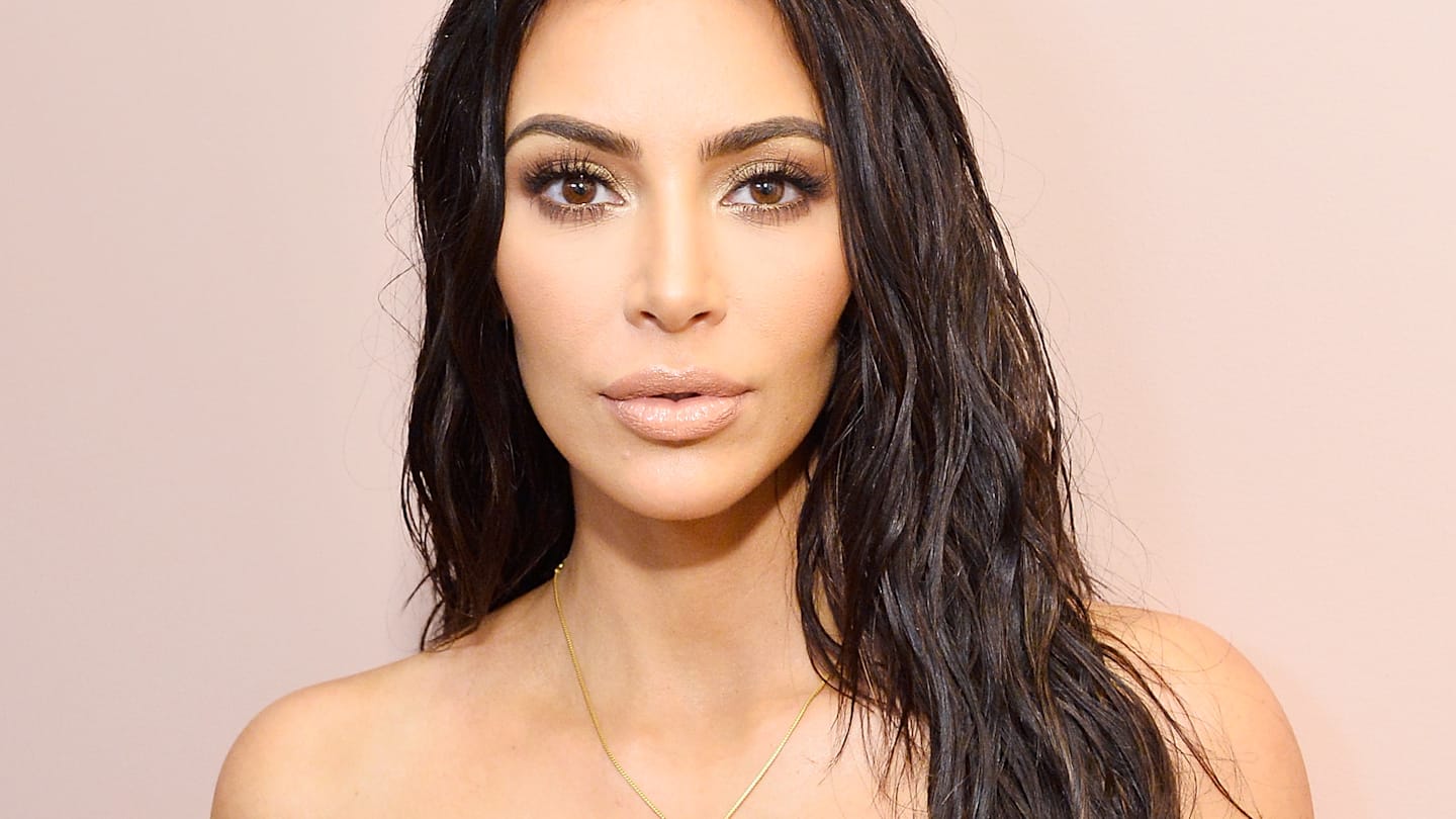 Kim Kardashian poses in scrunchie and pink ice skates in photo throwback