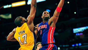 January 4, 2011; Los Angeles, CA, USA; Detroit Pistons shooting guard Tracy McGrady (1) goes in for a basket against the defense of Los Angeles Lakers center Andrew Bynum (17) during the first half at the Staples Center. Mandatory Credit: Gary A. Vasquez-Imagn Images