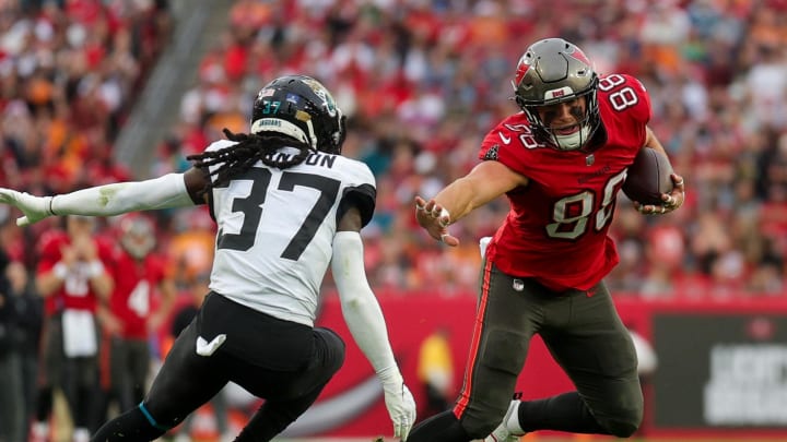 Dec 24, 2023; Tampa, Florida, USA;  Tampa Bay Buccaneers tight end Cade Otton (88) holds off Jacksonville Jaguars cornerback Tre Herndon (37) in the second quarter at Raymond James Stadium. Mandatory Credit: Nathan Ray Seebeck-USA TODAY Sports