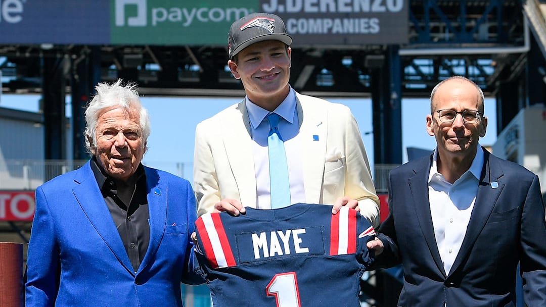 Apr 26, 2024; Foxborough, MA, USA; New England Patriots owner (L) Robert Kraft and president Jonathan Kraft (R) introduce the team's first round draft pick quarterback Drake Maye (C) on the game field at Gillette Stadium. Mandatory Credit: Eric Canha-Imagn Images
