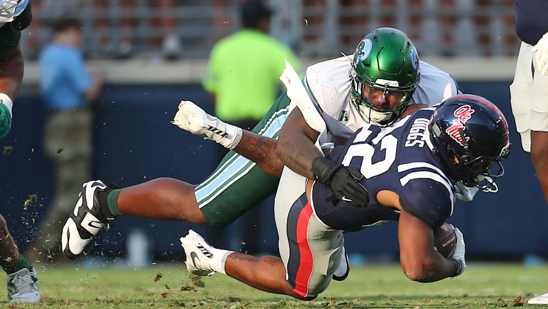 Sep 20, 2025; Oxford, Mississippi, USA; Tulane Green Wave defensive linemen Eliyt Nairne (90) tackles Mississippi Rebels running back Logan Diggs (22) during the fourth quarter at Vaught-Hemingway Stadium. Mandatory Credit: Petre Thomas-Imagn Images