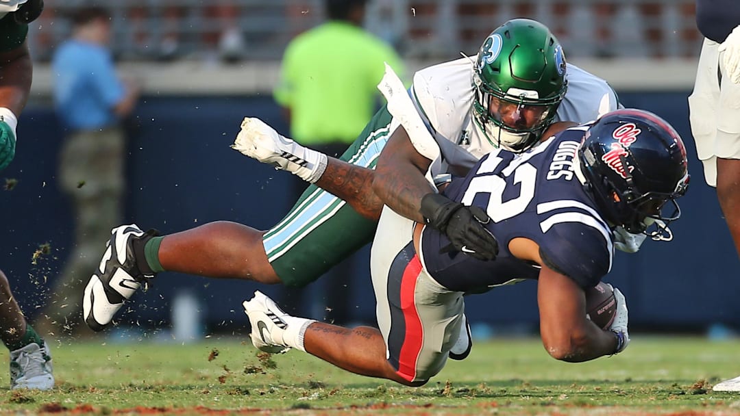 Sep 20, 2025; Oxford, Mississippi, USA; Tulane Green Wave defensive linemen Eliyt Nairne (90) tackles Mississippi Rebels running back Logan Diggs (22) during the fourth quarter at Vaught-Hemingway Stadium. Mandatory Credit: Petre Thomas-Imagn Images Sep 20, 2025; Oxford, Mississippi, USA; Tulane Green Wave defensive linemen Eliyt Nairne (90) tackles Mississippi Rebels running back Logan Diggs (22) during the fourth quarter at Vaught-Hemingway Stadium. Mandatory Credit: Petre Thomas-Imagn Images