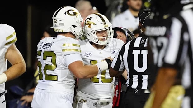 Georgia Tech Yellow Jackets quarterback Haynes King (10) celebrates his touchdown carry with offensive lineman Harrison Moore