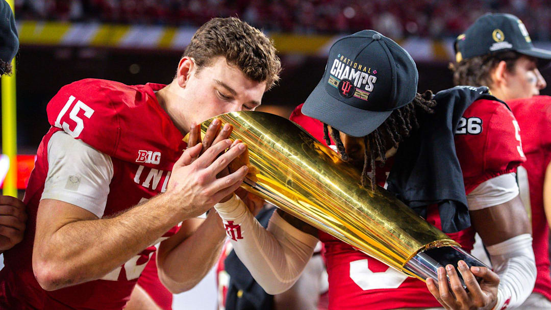 Indiana's Fernando Mendoza (15) an D'Angelo Ponds (5) kiss the trophy after the College Football Playoff National Championship college football game at Hard Rock Stadium in Miami Gardens on Monday, Jan. 19, 2026.
