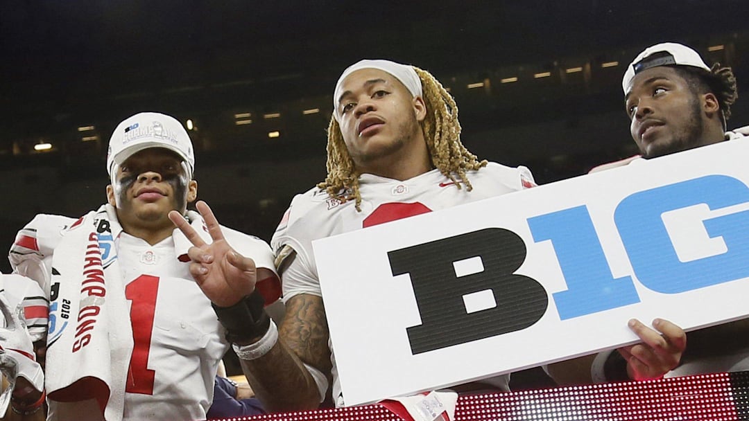 From left, Ohio State Buckeyes quarterback Justin Fields (1), defensive end Chase Young (2) and defensive end Tyreke Smith (11) celebrate their 34-21 win over the Wisconsin Badgers in the Big Ten Championship Game at Lucas Oil Stadium.