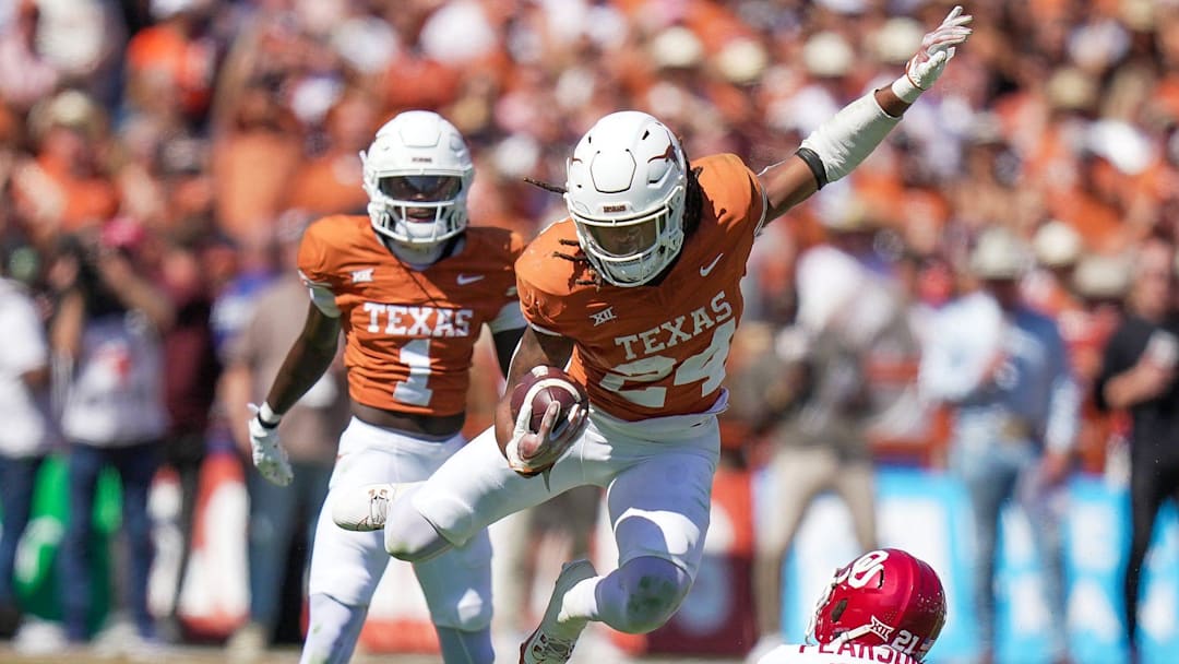 Texas Longhorns running back Jonathon Brooks (24) jumps over Oklahoma Sooners defensive back Reggie