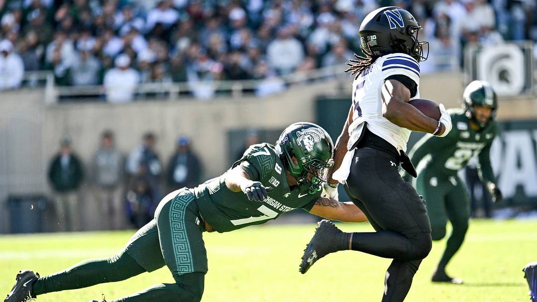 Michigan State’s Michael Richard, left, closes in on Northwestern’s Caleb Komolafe during the first quarter on Saturday, Oct. 17, 2026, at Spartan Stadium in East Lansing.