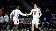 Cincinnati Bearcats guard Simas Lukosius (41) celebrates with Cincinnati Bearcats guard Day Day Thomas (1) after hitting a 3-point basket in the second half of the Big 12 Conference tournament between Cincinnati Bearcats and West Virginia Mountaineers at T-Mobile Center in Kansas City, Mo., on Tuesday, March 12, 2024.