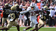 Sep 20, 2025; Blacksburg, Virginia, USA;  Virginia Tech Hokies running back Marcellous Hawkins (27) runs the ball as Wofford Terriers cornerback Cole Walker (23) defends during the first quarter at Lane Stadium. Mandatory Credit: Brian Bishop-Imagn Images