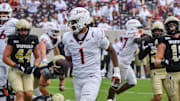Sep 20, 2025; Blacksburg, Virginia, USA;  Virginia Tech Hokies quarterback Kyron Drones (1) runs the ball for a touchdown during the fourth quarter against the the Wofford Terriers at Lane Stadium. Mandatory Credit: Brian Bishop-Imagn Images