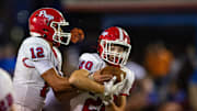 Jackson Prep Patriots' quarterback Parker Puckett (12) hands the ball off to running back Thomas Hewitt Oswalt (20) during the game against the Copiah Academy Colonels at Copiah in Hazlehurst, Miss., on Friday, Aug. 23, 2024.
