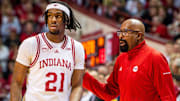 Indiana coach Mike Woodson (right) talks with sophomore forward Mackenzie Mgbako (21) during a game at Assembly Hall.  