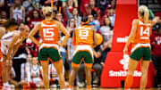 Miami (FL)'s Hanna Cavinder (15) and Haley Cavinder (14) watch Lashae Dwyer (13) shoot a free throw during the second half of the NCAA Tournament Second Round game between Indiana and Miami (FL) at Simon Skjodt Assembly Hall on Monday, March 20, 2023.

Iu Um Wbb 2h Cavinder Twins