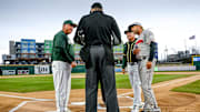 Michigan State's head coach Jake Boss Jr., left, Athletics scout Rich Sparks, center, and Lugnuts' manager Craig Conklin, right, meet with the umpire on Tuesday, April 4, 2023, before the Crosstown Showdown at Jackson Field in Lansing.

230404 Msu Lugnuts Bsball 011a