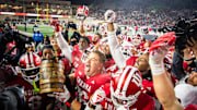 Indiana's Mike Katic and the Hoosiers hoist the bucket after the Indiana versus Purdue football game at Memorial Stadium.