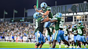 Quarterback Jake Retzlaff celebrates with his teammates after scoring a touchdown