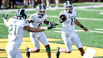 Michigan State's Connor Heyward, right, celebrates with teammates Jalen Nailor, center, and Chase Kline after Heyward recovered the Michigan onside kick late during the fourth quarter on Saturday, Oct. 31, 2020, at Michigan Stadium in Ann Arbor.

201031 Msu Um 188a