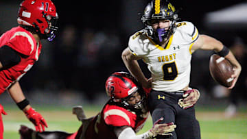 Verot quarterback Carter Smith is taken down by a defender. The Bishop Verot Vikings varsity football team lost to Cardinal Mooney High School in the Region 2A-3 final game Friday, Nov. 29, 2024. Cardinal Mooney will move on to the state final four playoff. Cardinal Mooney won with a final score of 35-14.