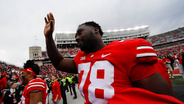 Ohio State Buckeyes offensive tackle Nicholas Petit-Frere (78) waves to the crowd as he leaves the field following their 56-7 win over the Michigan State Spartans in the NCAA football game at Ohio Stadium in Columbus on Saturday, Nov. 20, 2021. Petit-Frere was honored earlier in the game during the Senior Day ceremony.