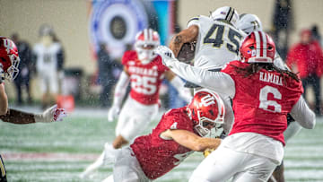 Indiana's Aiden Fisher (4) tackles Purdue's Devin Mockobee (45) during the Indiana versus Purdue football game at Memorial Stadium on Saturday, Nov. 30, 2024.