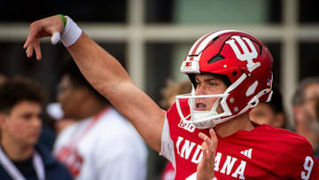 Indiana's Kurtis Rourke (9) gets loose before the start of the Indiana versus Michigan football game at Memorial Stadium on Friday, Nov. 9, 2024.