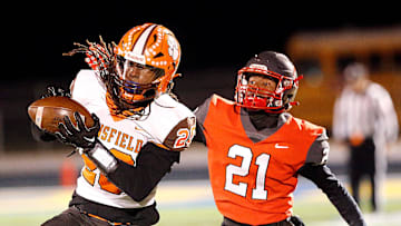 Mansfield Senior High School's Elias Owens (20) catches a pass against Toledo Central Catholic High School's Victor Singleton Jr. (21) during their OHSAA Division III Region 10 high school football semifinal game action Friday, Nov. 10, 2023 at Bob Bishop Stadium in Clyde. TOM E. PUSKAR/MANSFIELD NEWS JOURNAL