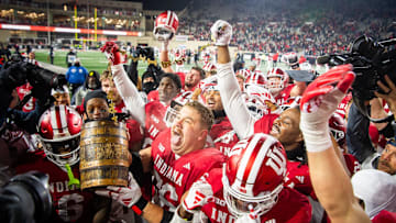 Indiana's Mike Katic (56) and the Hoosiers hoist the bucket after the Indiana versus Purdue football game at Memorial Stadium on Saturday, Nov. 30, 2024.
