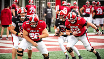 Indiana's Mike Katic (56) and Drew Evans (62) work through a drill during practice at Memorial Stadium on Tuesday, March 26, 2024.