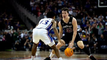 Cincinnati Bearcats guard Simas Lukosius (41) handles the ball as Kansas Jayhawks guard Elmarko Jackson (13) guards him in the second half of the Big 12 Conference tournament game between Cincinnati Bearcats and Kansas Jayhawks at T-Mobile Center in Kansas City, Mo., on Wednesday, March 13, 2024.