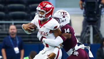 Sep 28, 2024; Arlington, Texas, USA;  Texas A&M Aggies defensive back Jayvon Thomas (14) tackles Arkansas Razorbacks quarterback Taylen Green (10) during the first half at AT&T Stadium. Mandatory Credit: Kevin Jairaj-Imagn Images