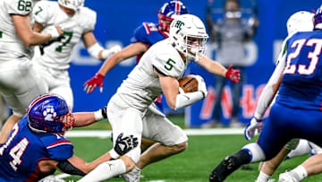 Forest Hills Central's Ty Hudkins runs for a gain against Mason during the first quarter on Sunday, Nov. 26, 2023, at Ford Field in Detroit.