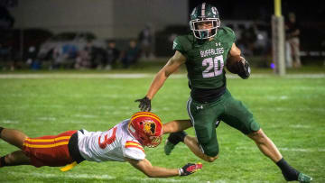 Manteca's Blake Nichelson (20), right, fends off Oakdale's Zachary Stott (23) during a varsity football game at Manteca's Guss Schmiedt Stadium on Friday, Oct. 28, 2022.

Fb Esc Mant 082a