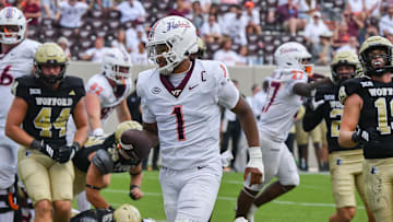 Sep 20, 2025; Blacksburg, Virginia, USA;  Virginia Tech Hokies quarterback Kyron Drones (1) runs the ball for a touchdown during the fourth quarter against the the Wofford Terriers at Lane Stadium. Mandatory Credit: Brian Bishop-Imagn Images